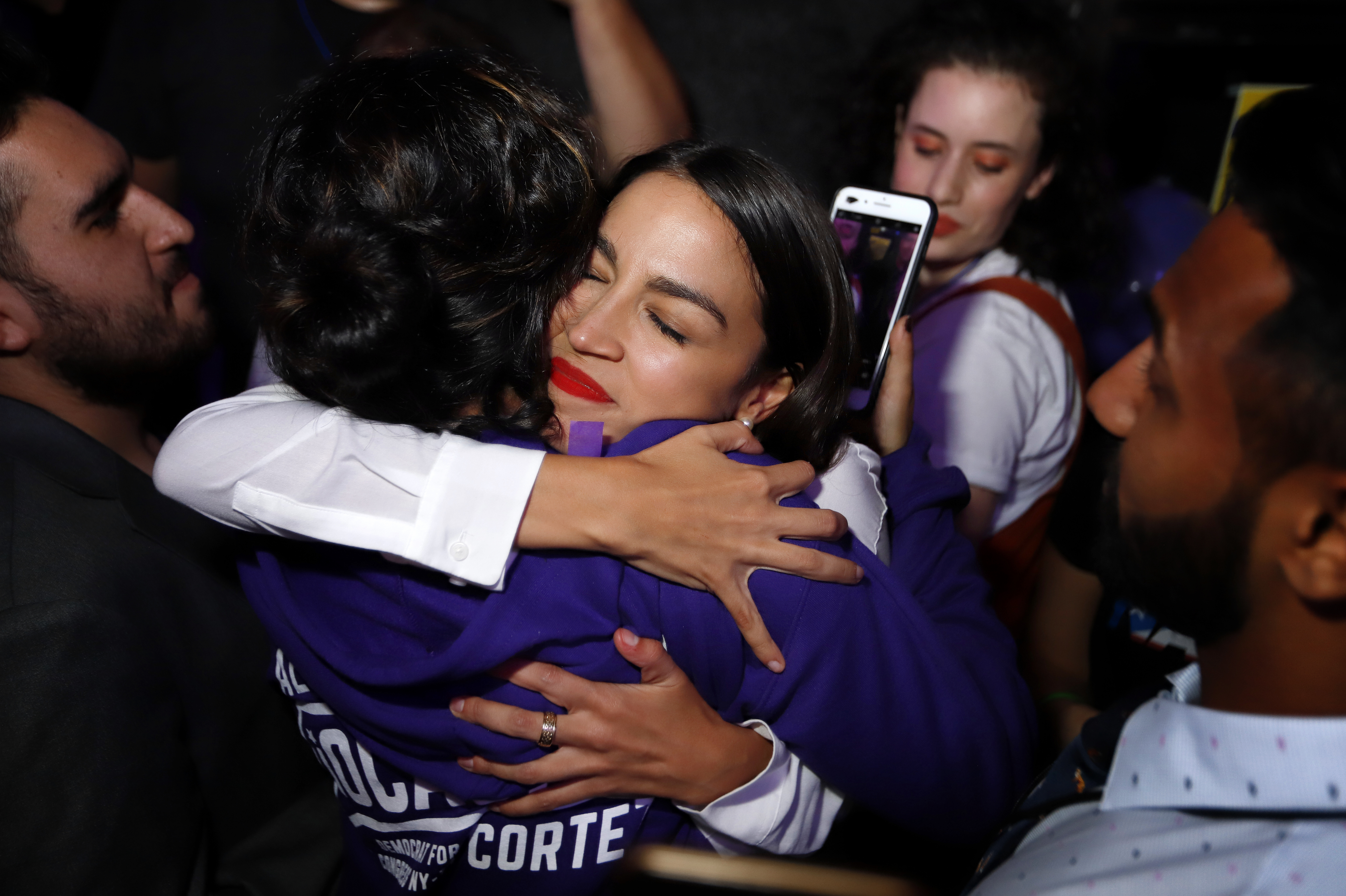 Alexandria Ocasio-Cortez hugs a supporter during her victory celebration at La  Boom night club in Queens, New York City. - WJCT Public Media