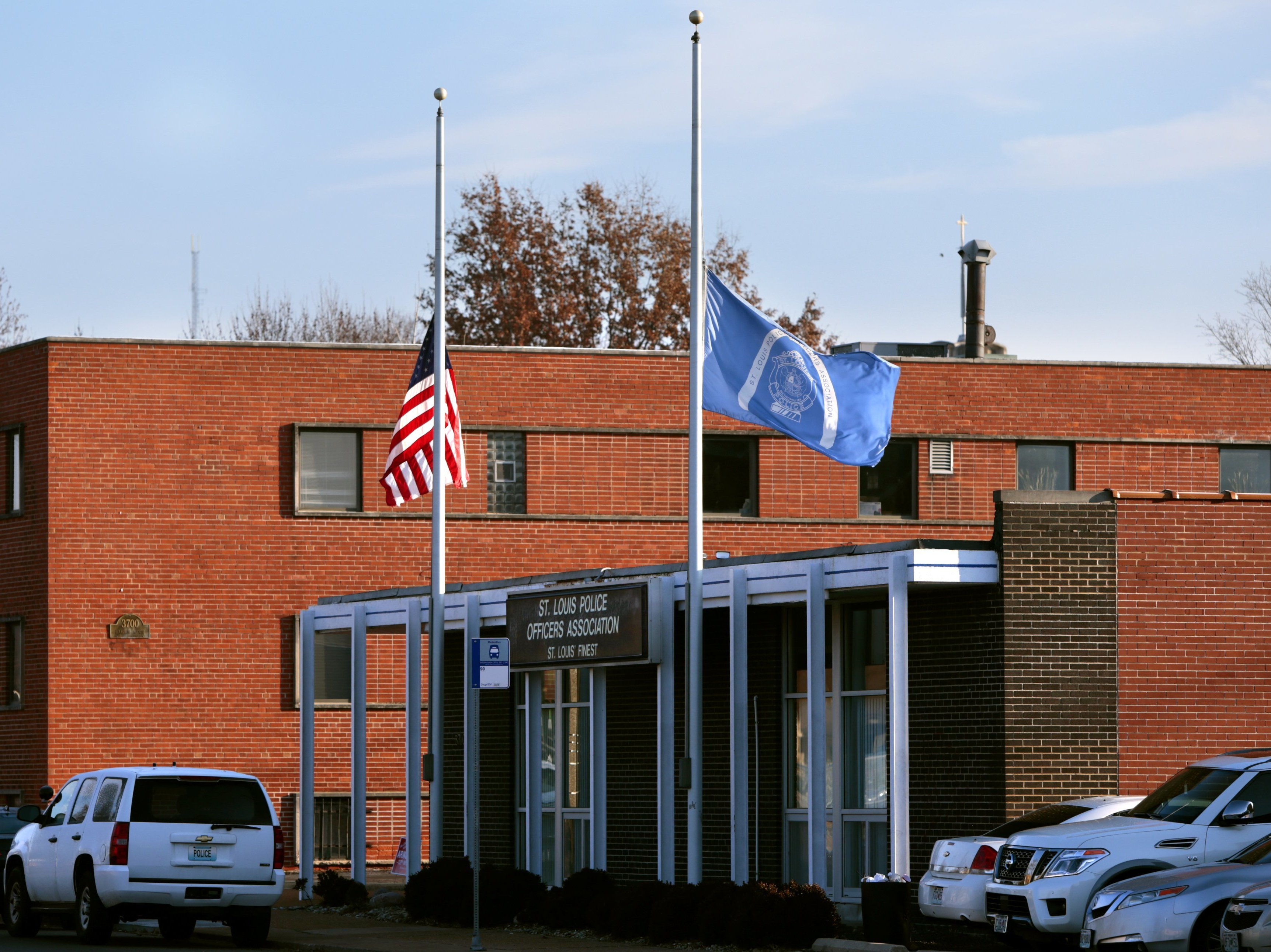 Flags fly at half-staff in front of the St. Louis Police Officers Association, following the ...