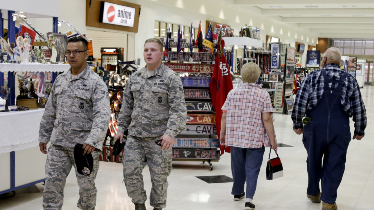 Soldiers and civilians walk through a store on Offutt Air Force Base in