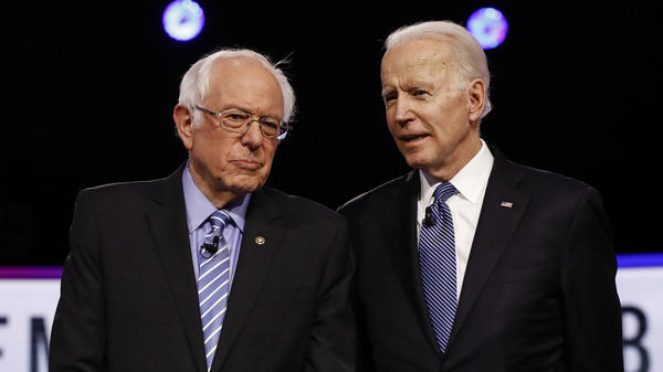 Democratic presidential candidates, Sen. Bernie Sanders,and former Vice President Joe Biden, talk before a the February Democratic presidential primary debate. Credit: Associated Press