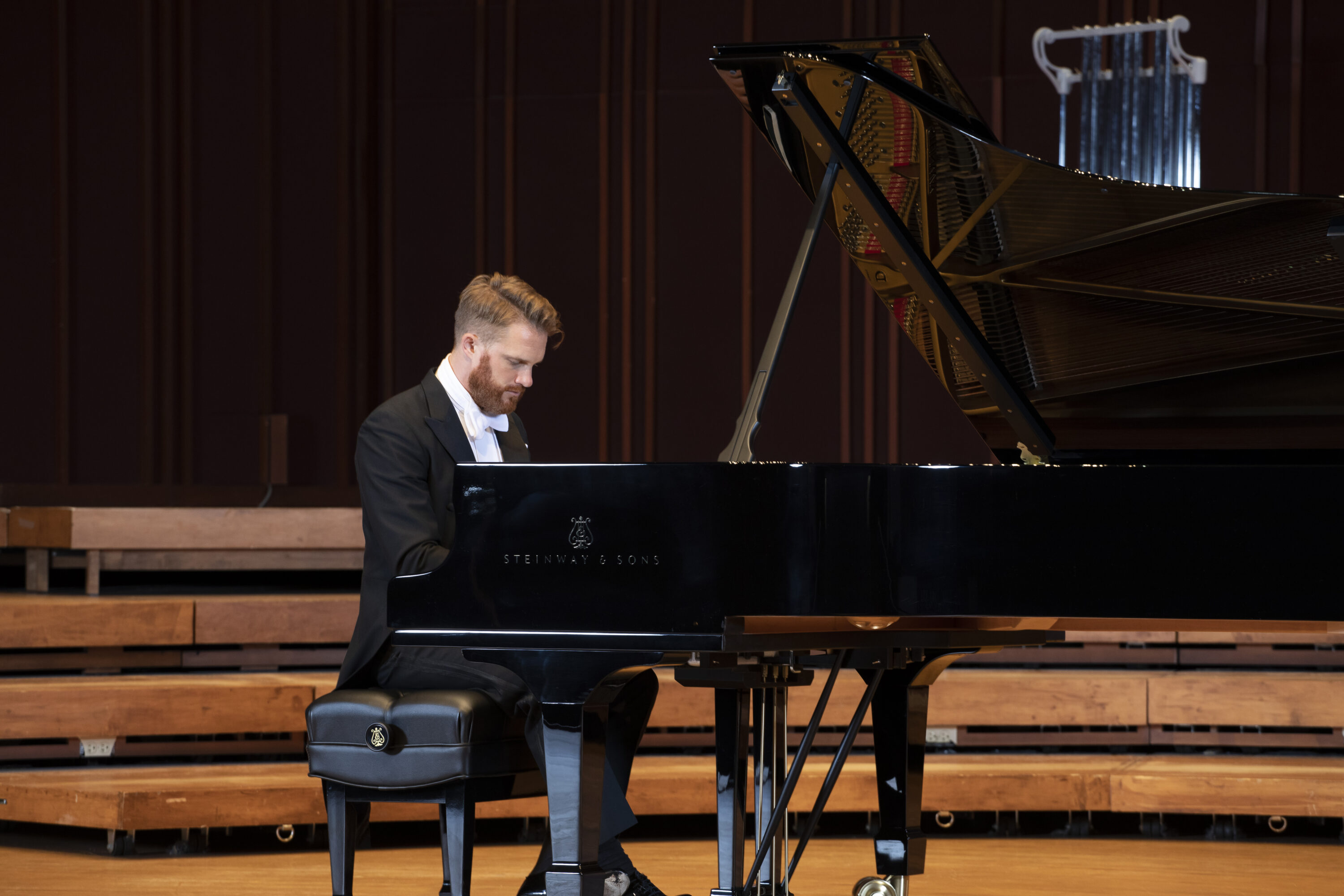 Photograph of Courtney Lewis playing piano